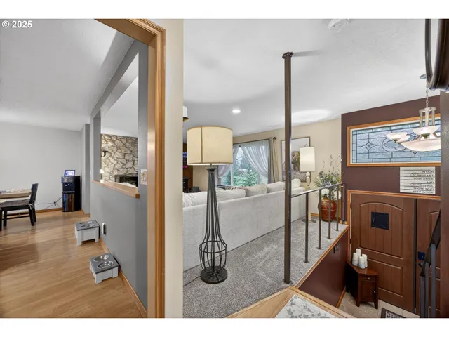 a living room with furniture a flat screen tv and a floor to ceiling window