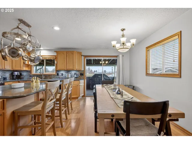 a view of a dining room with furniture and chandelier