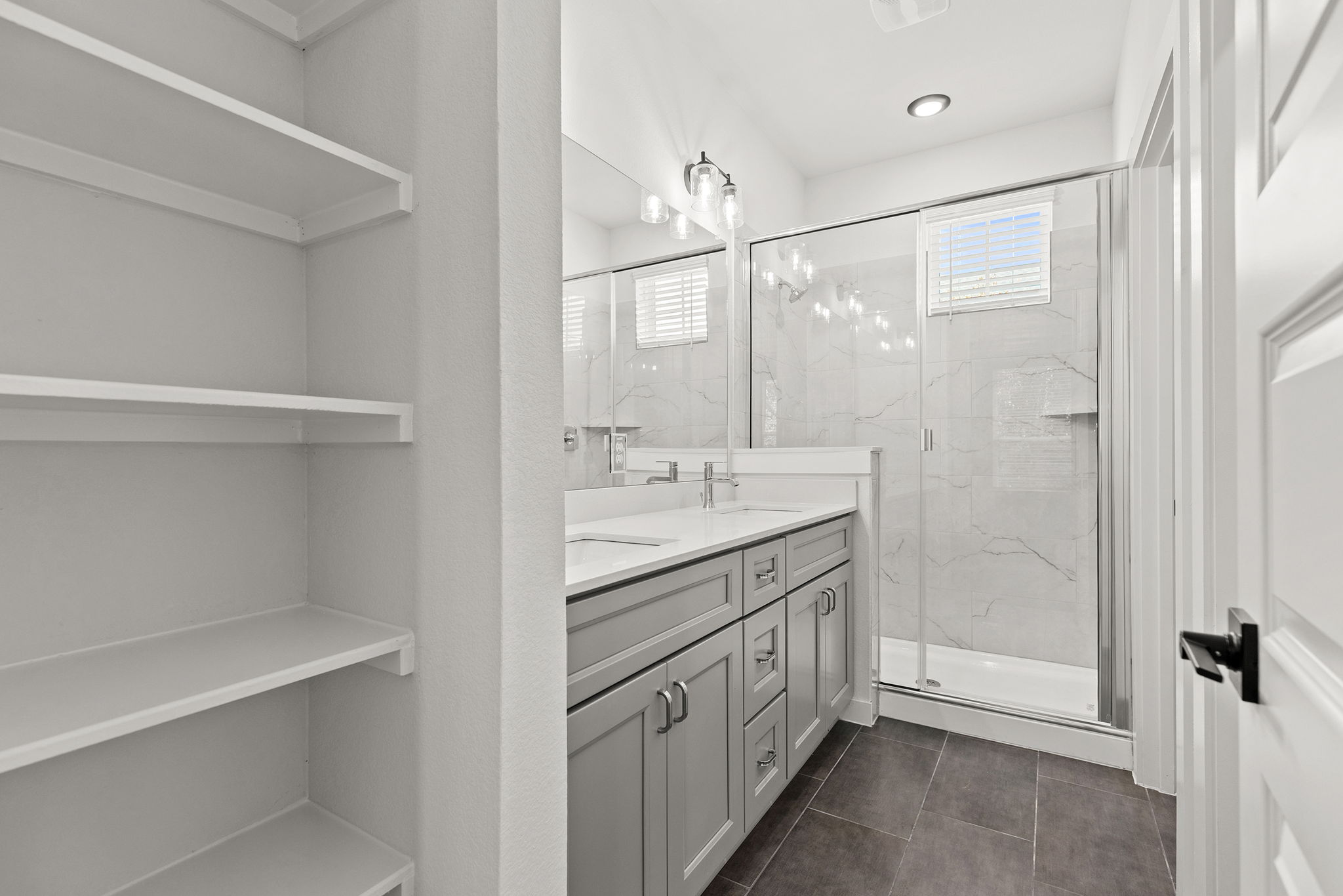 2600 Gattis School Road, Unit 1001 Round Rock, TX 78664 - Photo 22 of 40 Dual vanities and a spacious glass-enclosed shower create a rejuvenating sanctuary.