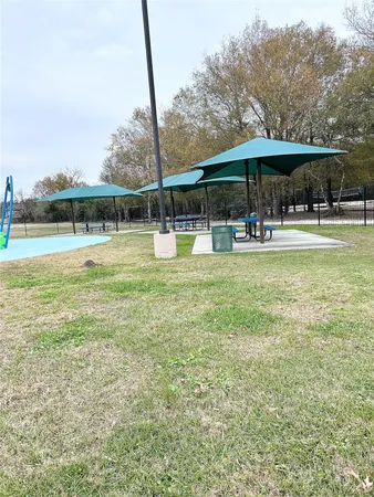 a view of a swimming pool with a table and chairs under an umbrella