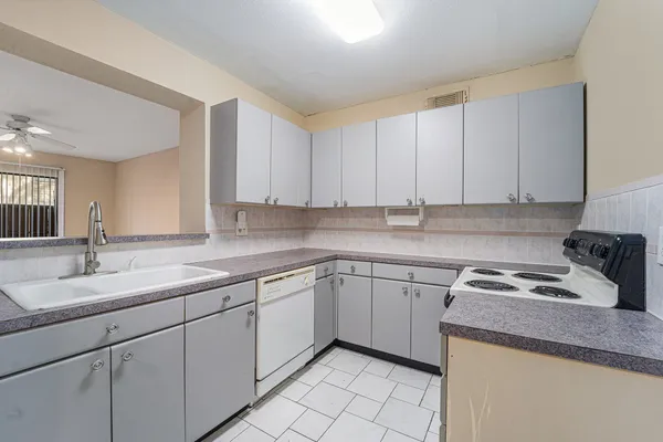a kitchen with sink cabinets and window