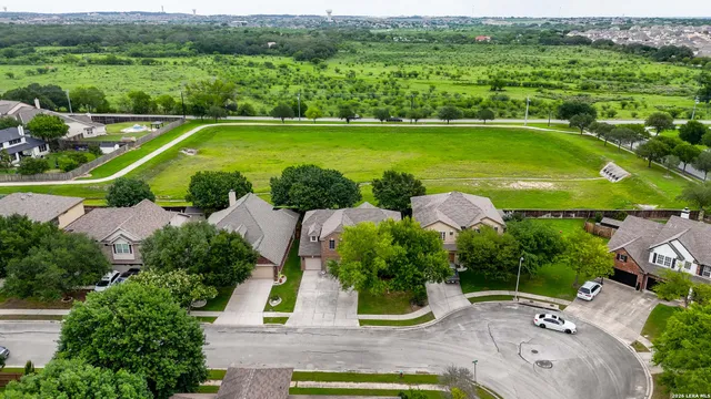 an aerial view of a house with a garden and lake view