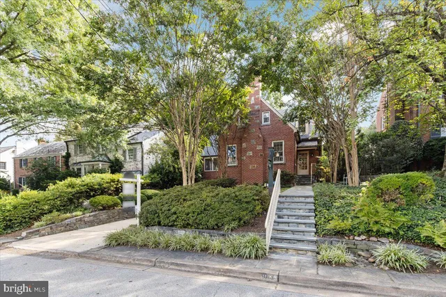 front view of a house with a tree
