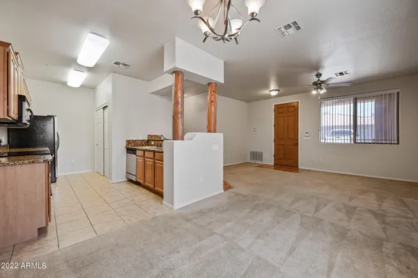 a view of a kitchen with furniture and a ceiling fan