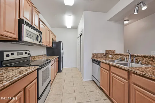 a kitchen with stainless steel appliances granite countertop a stove and a sink