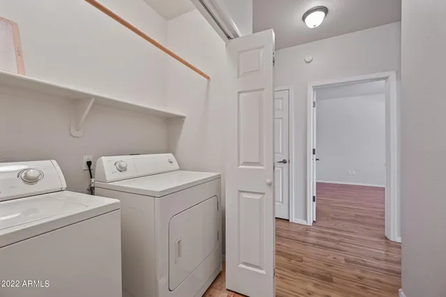 a view of storage and utility room with washer and dryer
