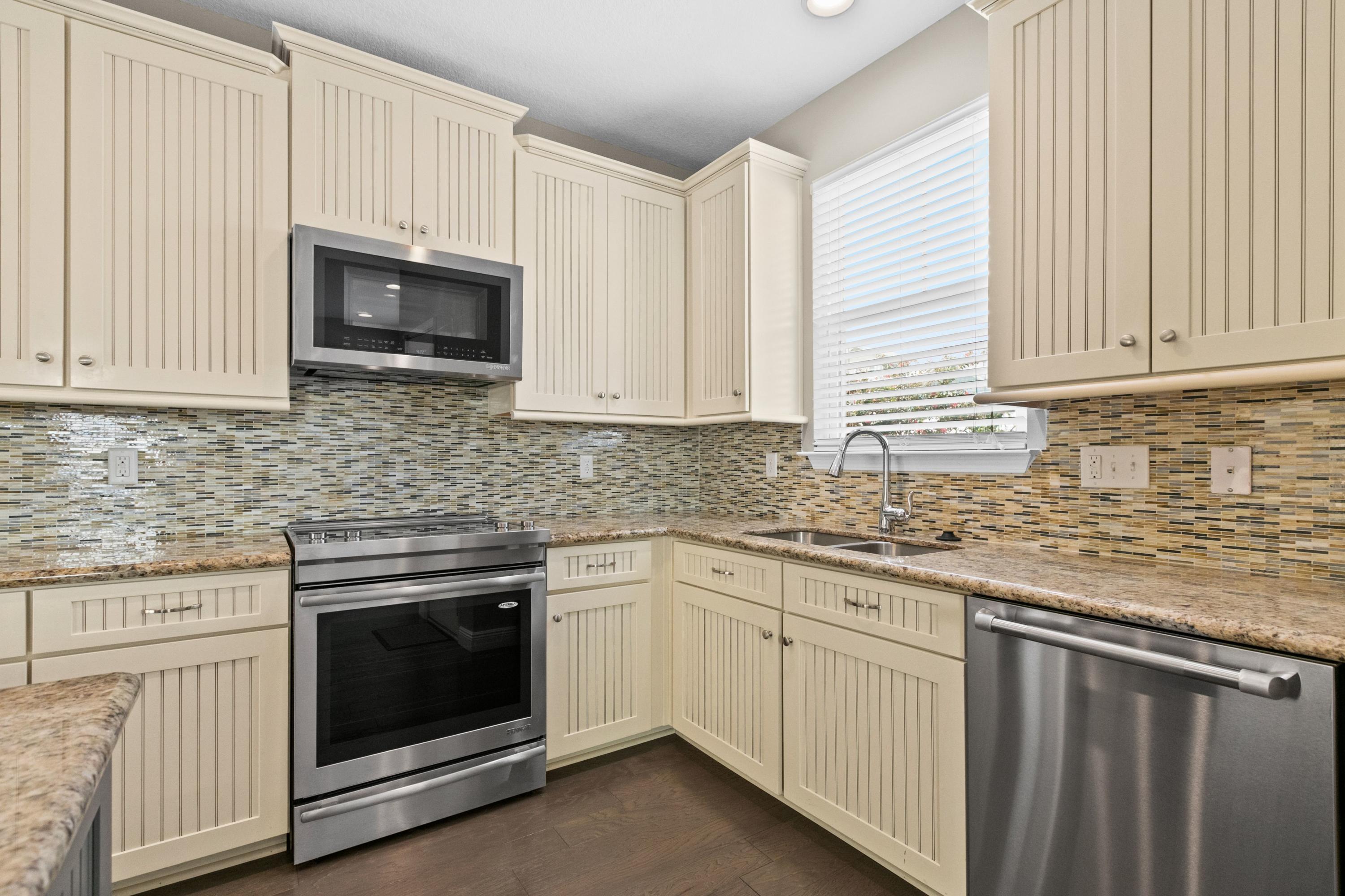 27 Inlet Cove Inlet Beach, FL 32461 - Photo 11 of 31 a kitchen with granite countertop white cabinets white stainless steel appliances and a sink