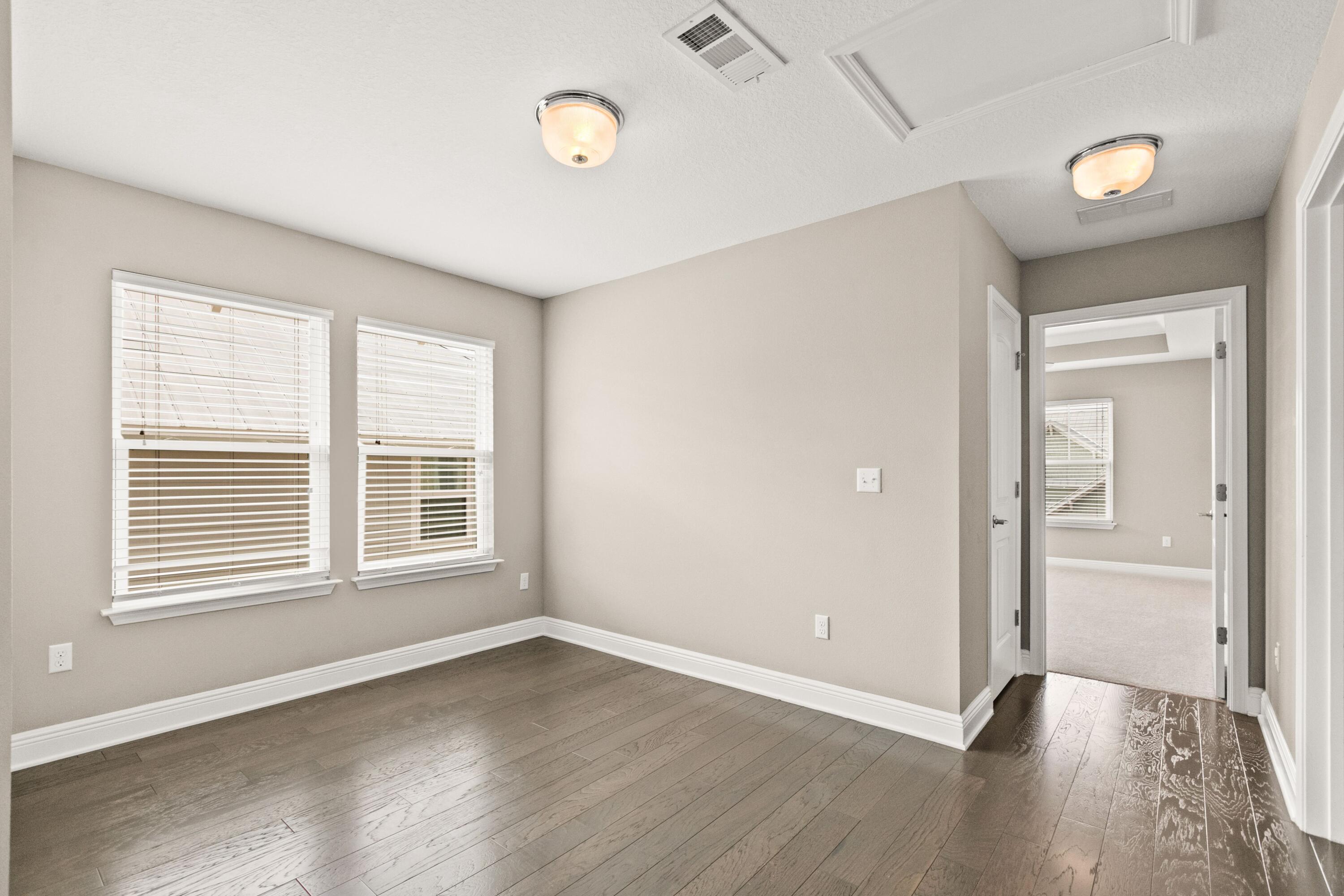 27 Inlet Cove Inlet Beach, FL 32461 - Photo 17 of 31 an empty room with wooden floor and windows