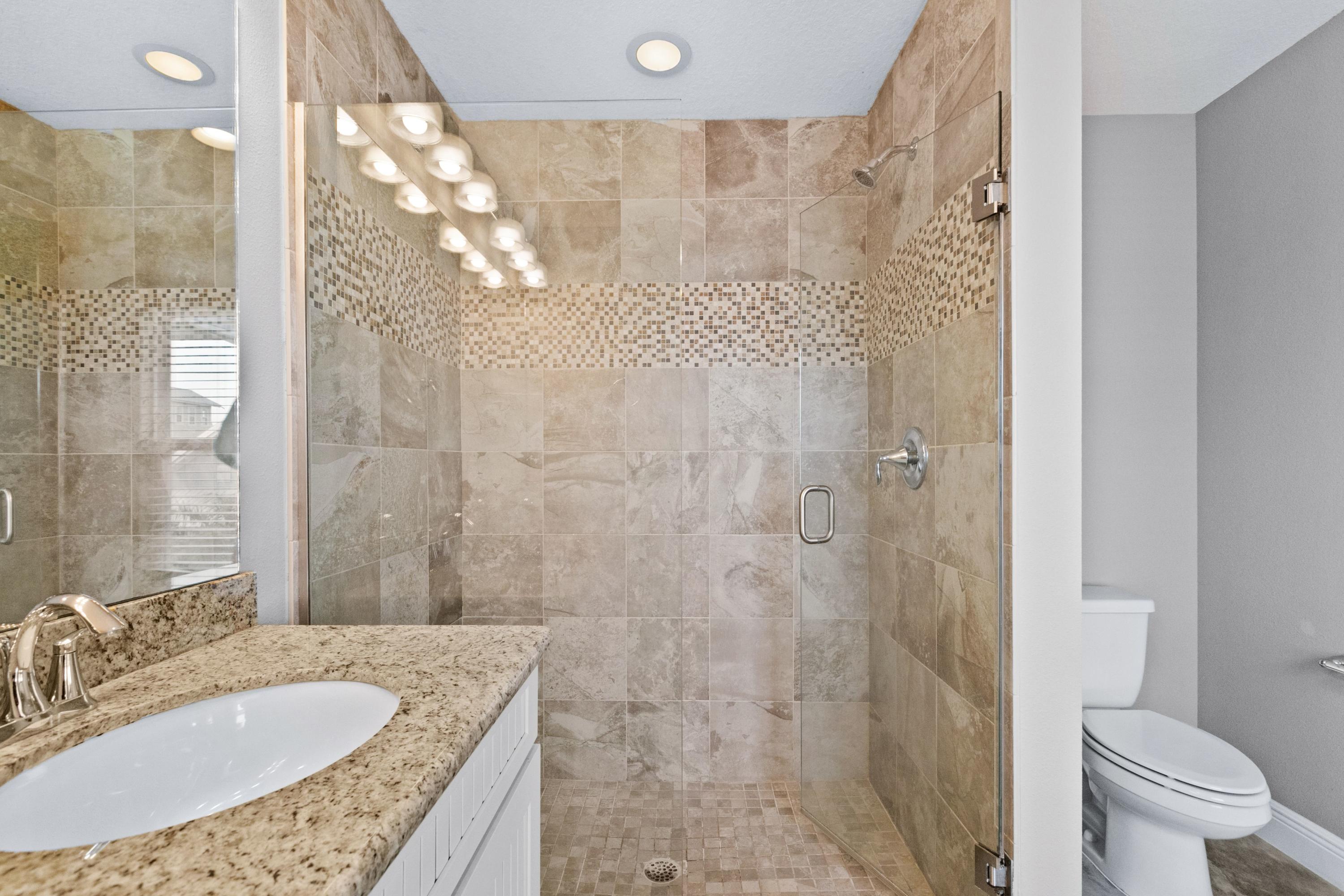 27 Inlet Cove Inlet Beach, FL 32461 - Photo 21 of 31 a bathroom with a granite countertop sink a toilet and shower