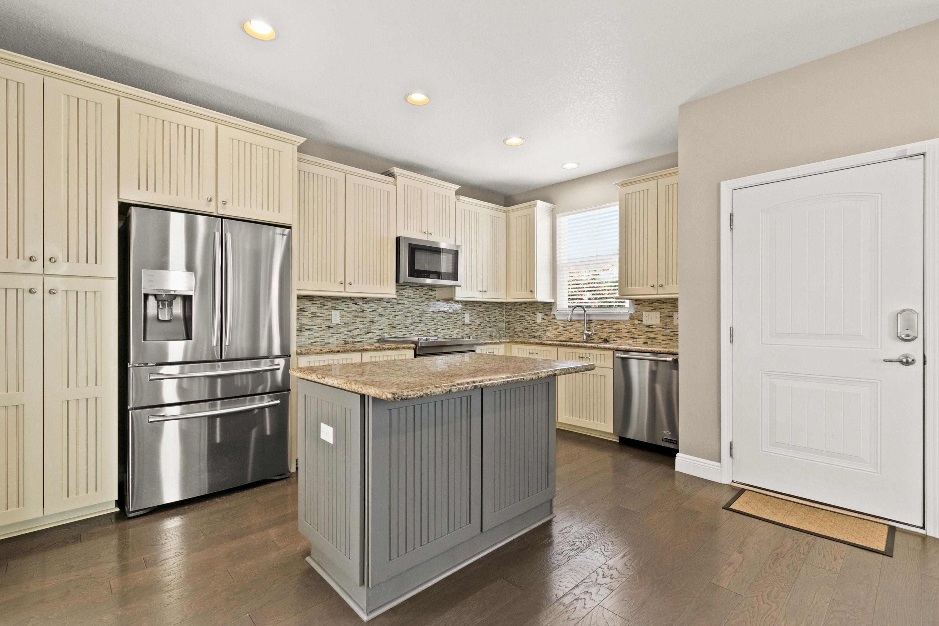 27 Inlet Cove Inlet Beach, FL 32461 - Photo 6 of 31 a kitchen with white cabinets and stainless steel appliances