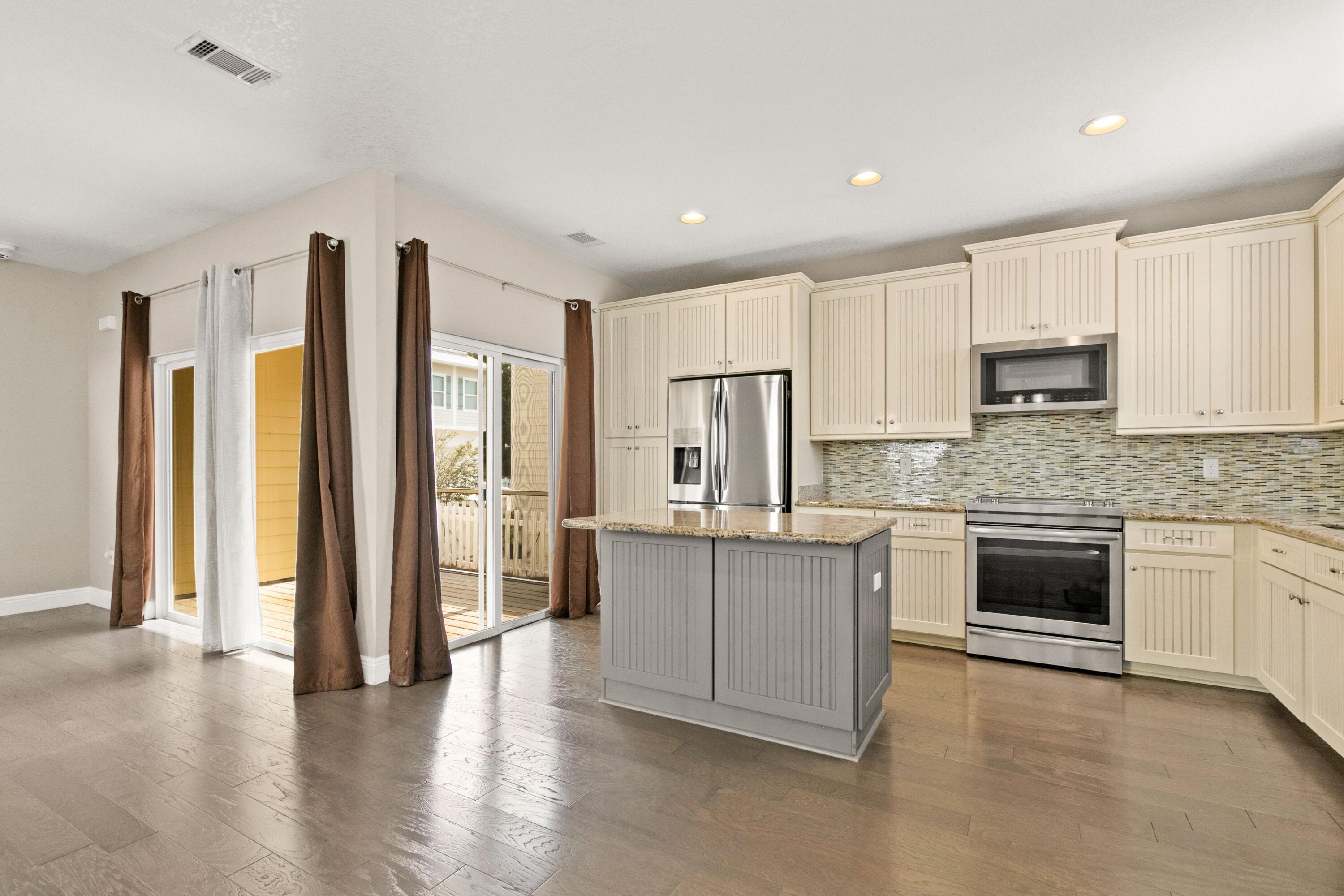 27 Inlet Cove Inlet Beach, FL 32461 - Photo 10 of 31 a large kitchen with stainless steel appliances granite countertop a stove and a refrigerator
