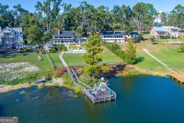 an aerial view of a house with garden space and lake view