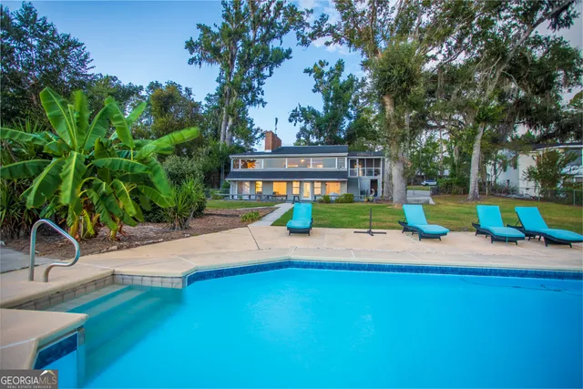 swimming pool with outdoor seating and yard