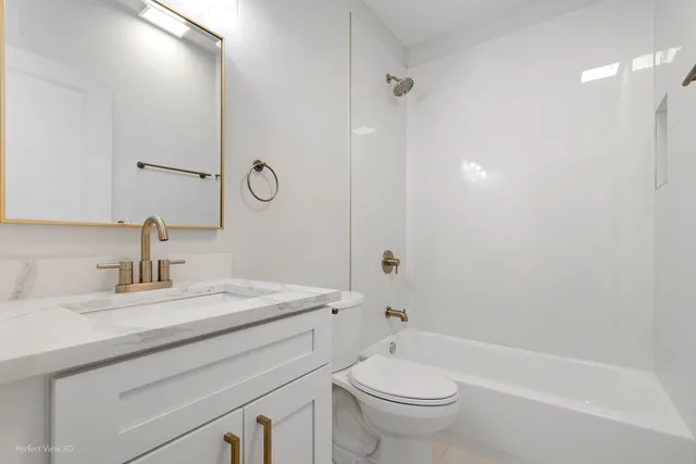 a bathroom with a granite countertop sink a toilet and a bathtub