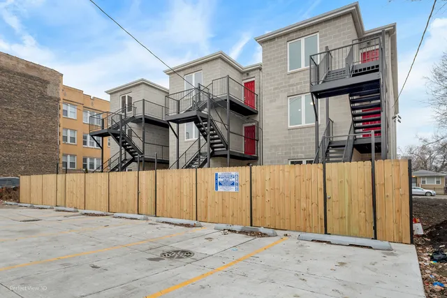 a street sign on a wall next to a road