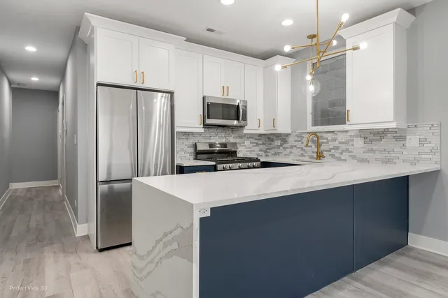 a kitchen with stainless steel appliances a refrigerator sink and microwave