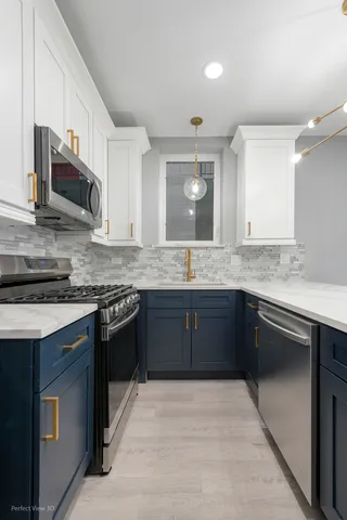 a kitchen with stainless steel appliances granite countertop a sink stove and microwave
