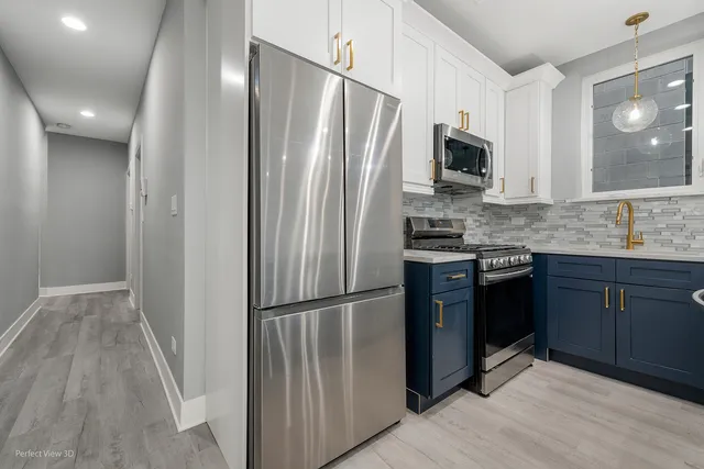 a kitchen with stainless steel appliances granite countertop a refrigerator stove and sink