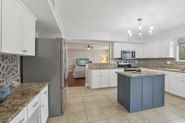 a kitchen with a sink a counter top space and cabinets