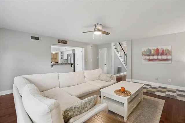 a living room with furniture and a chandelier