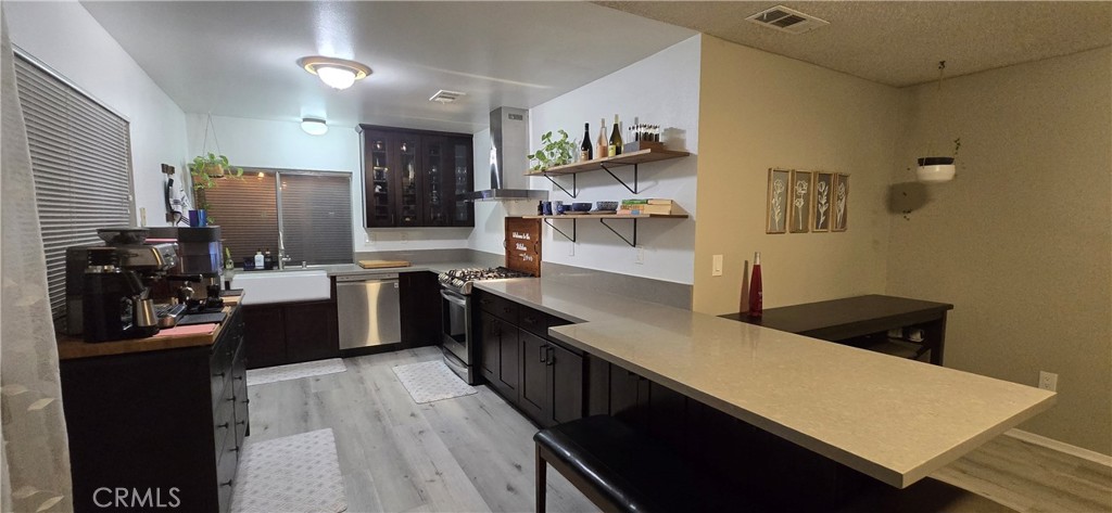 6830 Astoria Drive Riverside, CA 92503 - Photo 8 of 23 a kitchen with granite countertop a refrigerator stove and sink