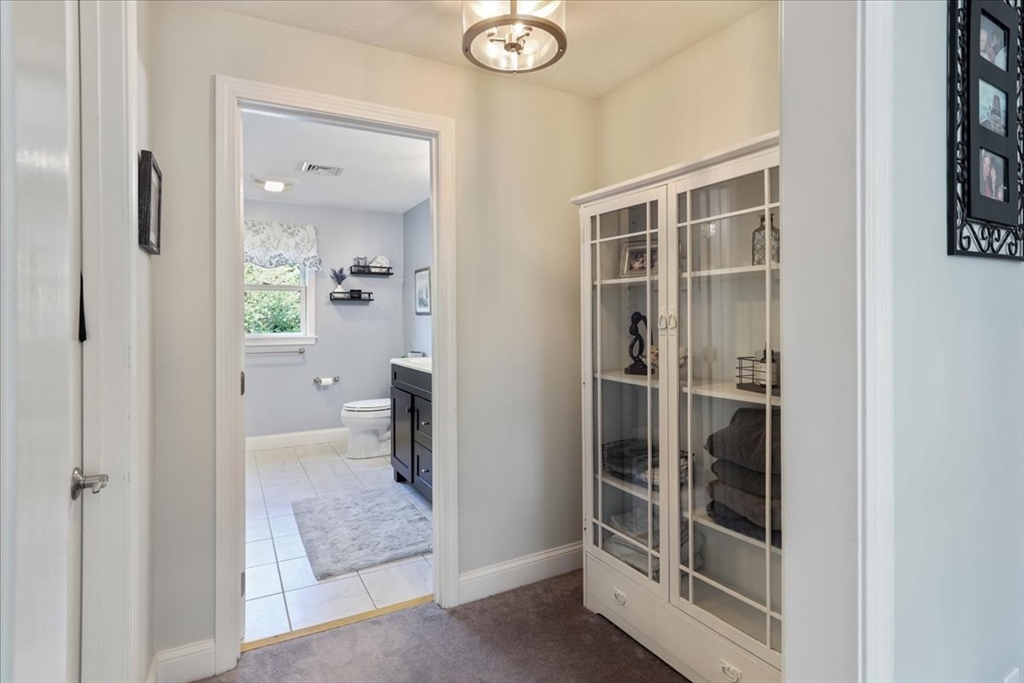 22 Constitution Way Hanson, MA 02341 - Photo 24 of 40 a view of a hallway with wooden floor and a living room