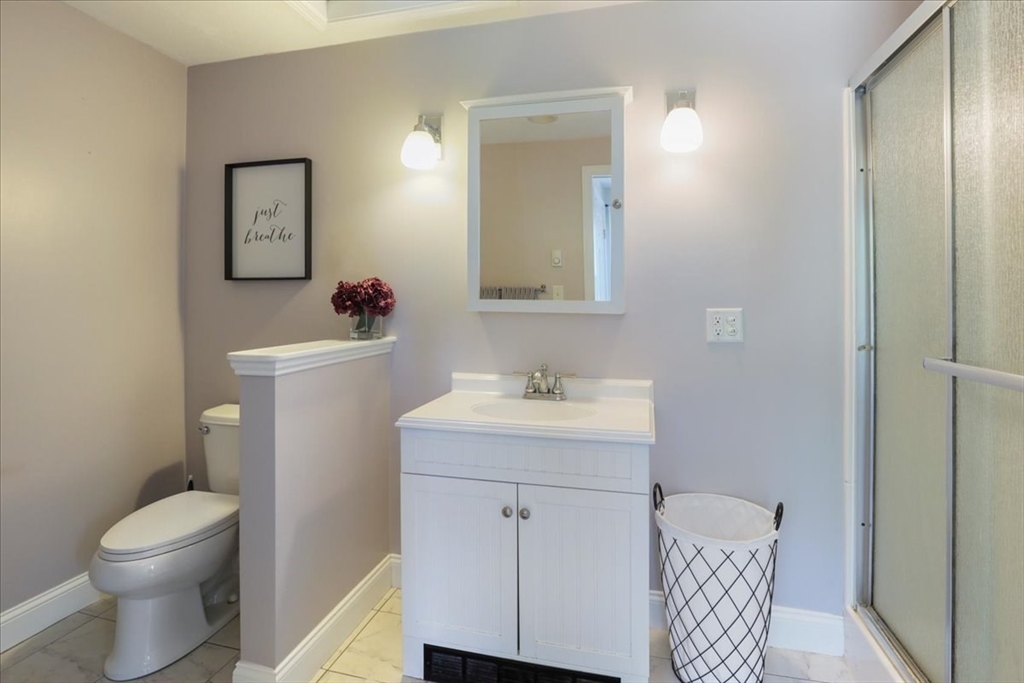 22 Constitution Way Hanson, MA 02341 - Photo 32 of 40 a bathroom with a sink toilet and vanity