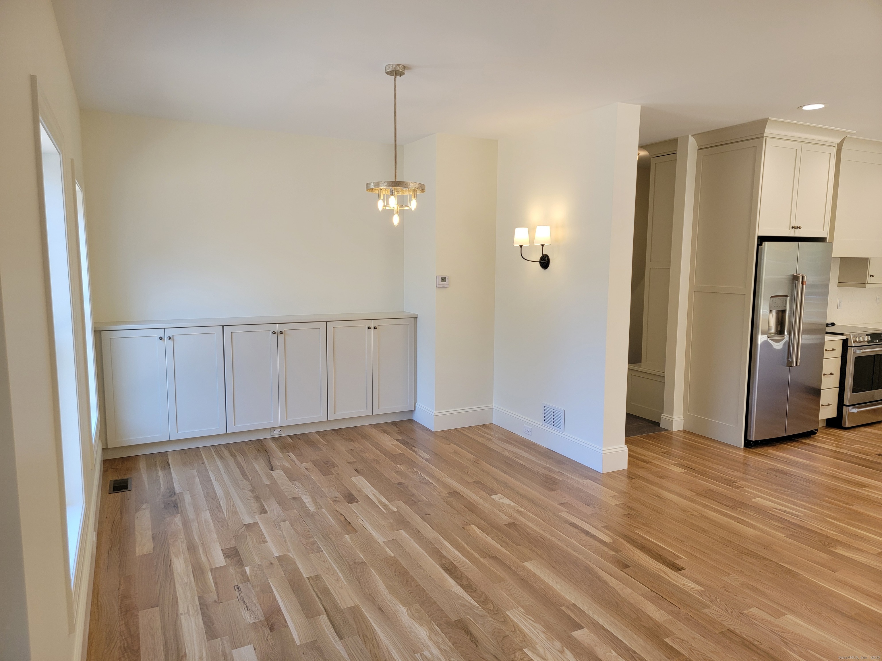 963 High Road Berlin, CT 06037 - Photo 16 of 39 a view of an empty room with wooden floor kitchen view and a window