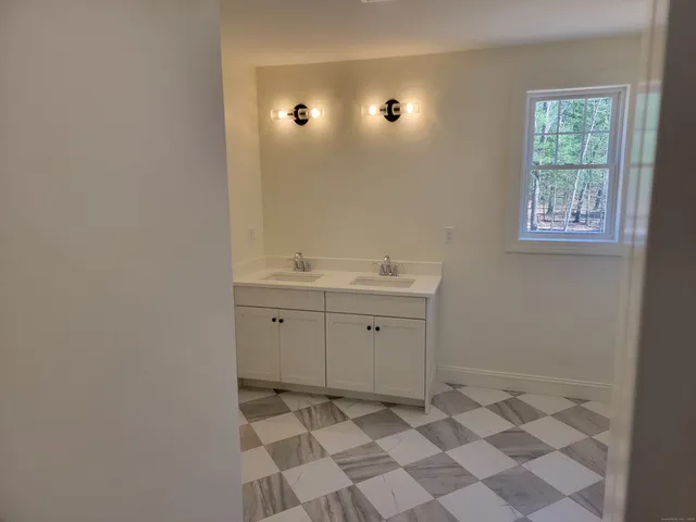 a view of a bathroom with a sink and a mirror