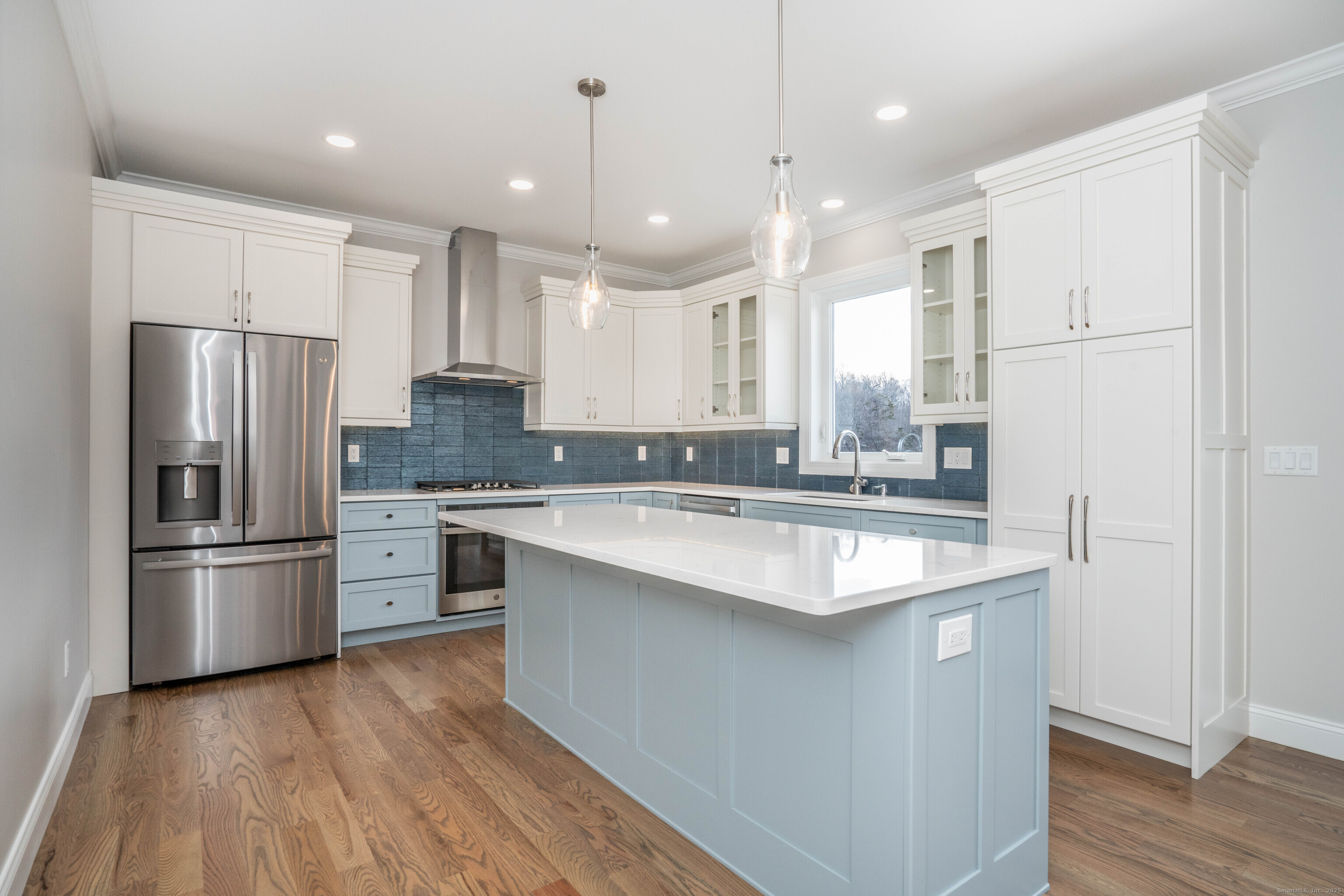 963 High Road Berlin, CT 06037 - Photo 24 of 39 a kitchen with stainless steel appliances granite countertop a refrigerator a sink dishwasher a stove and white countertops with wooden floor