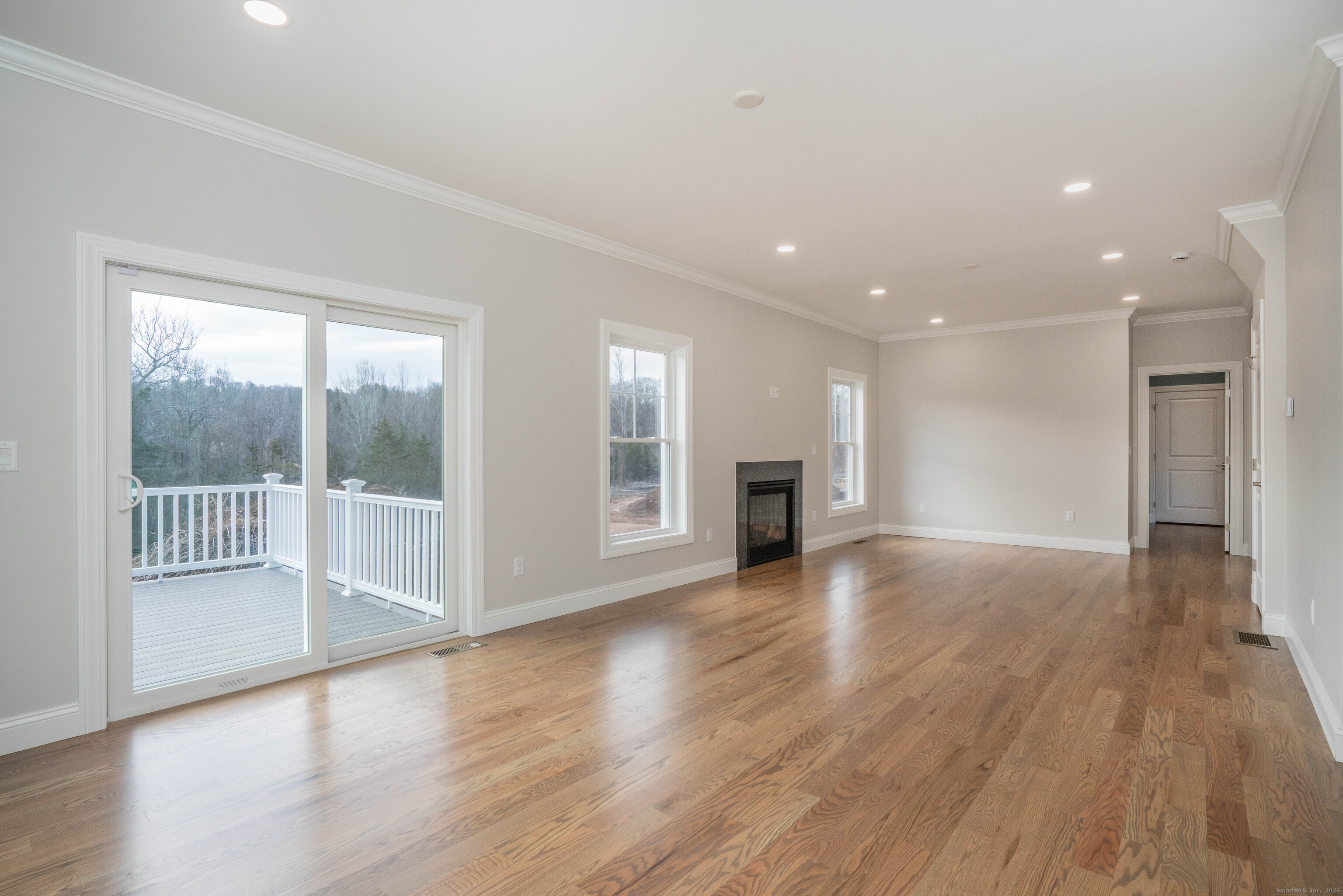 963 High Road Berlin, CT 06037 - Photo 26 of 39 a view of empty room with wooden floor and fireplace
