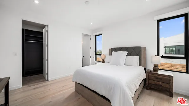 a bedroom with a bed and a couch