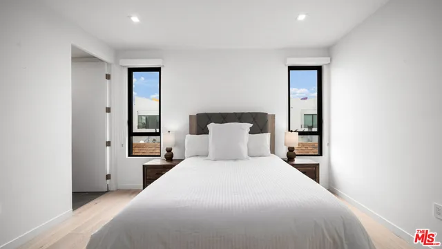 a bedroom with a bed and a night stand