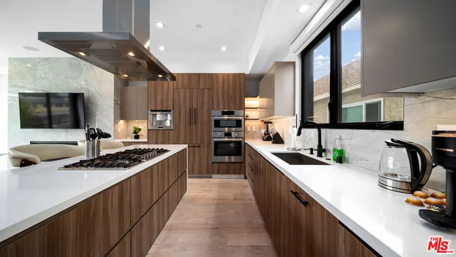 a kitchen with stainless steel appliances a sink stove and cabinets