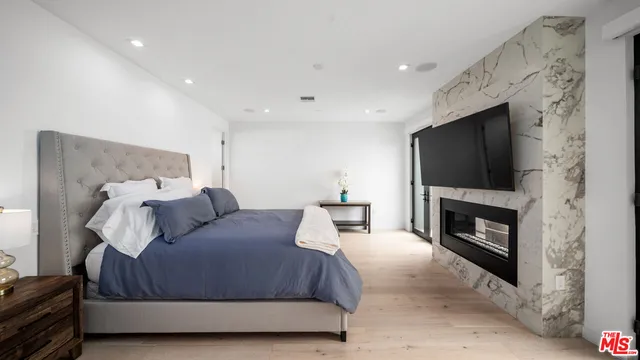 a bedroom with a bed and a fireplace