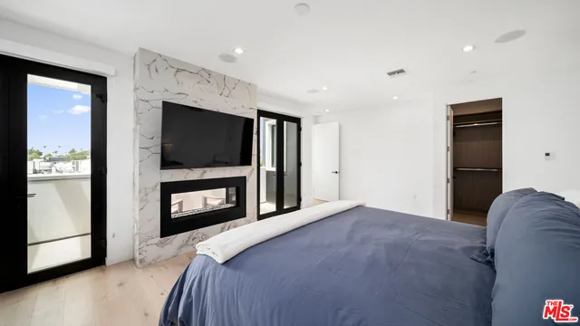 a bedroom with a bed and a television