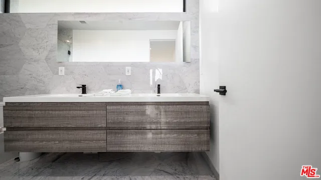 a bathroom with a sink a mirror and vanity