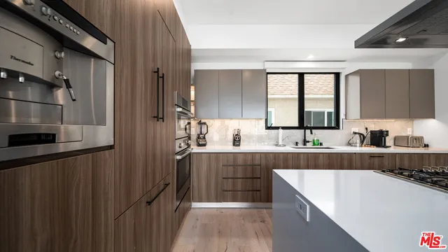 a kitchen with counter top space and cabinets