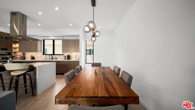 a view of a kitchen with kitchen island a counter space a sink and appliances