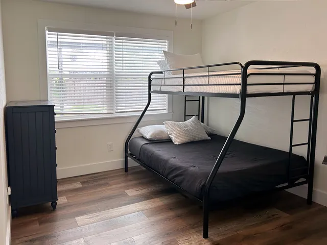 a bedroom with a bed and a chandelier