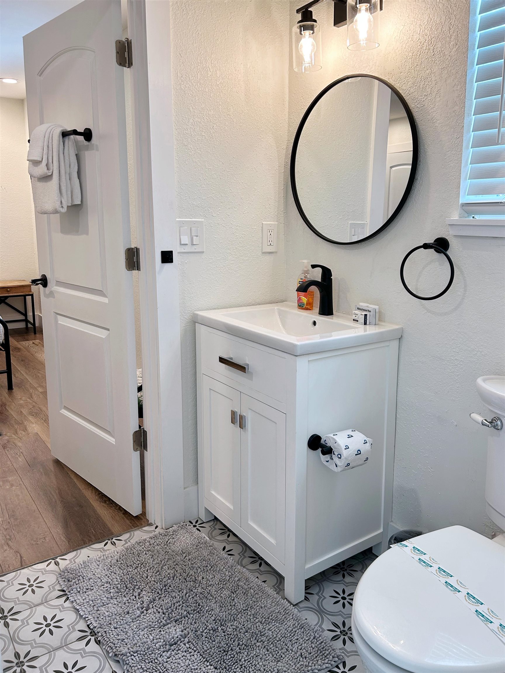 155 Drake Road St. Augustine, FL 32086 - Photo 17 of 32 a bathroom with a toilet a sink and mirror