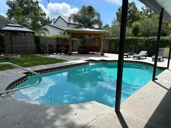 a front view of a house with a yard and mountain