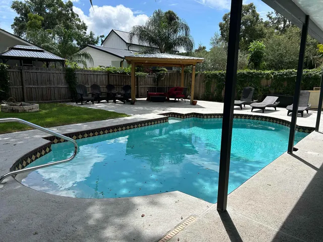 a front view of a house with a yard and mountain