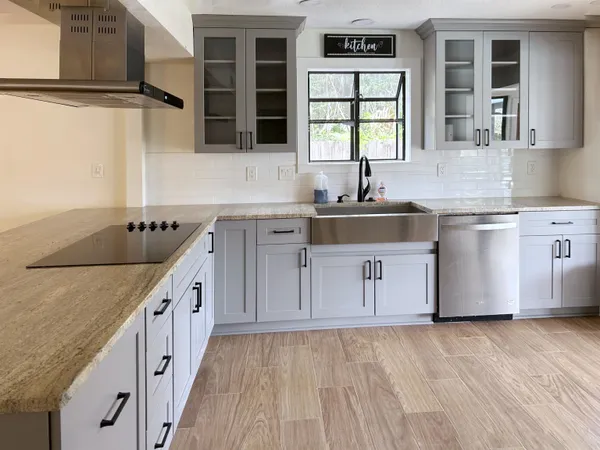 a living room with furniture a flat screen tv and a window