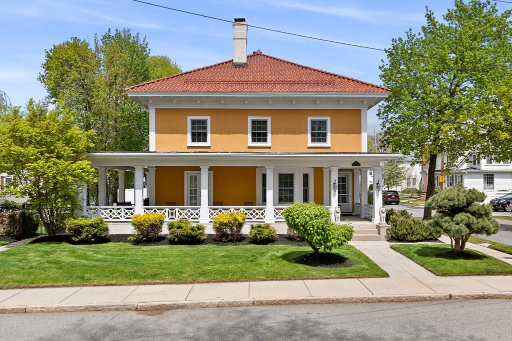 79 Wedge Street Lowell, MA 01851 - Photo 1 of 42 a front view of a house with garden