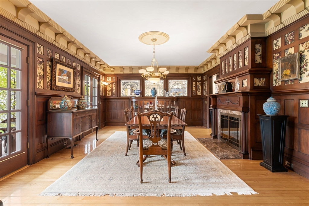 79 Wedge Street Lowell, MA 01851 - Photo 11 of 42 a dining room with furniture and a fireplace