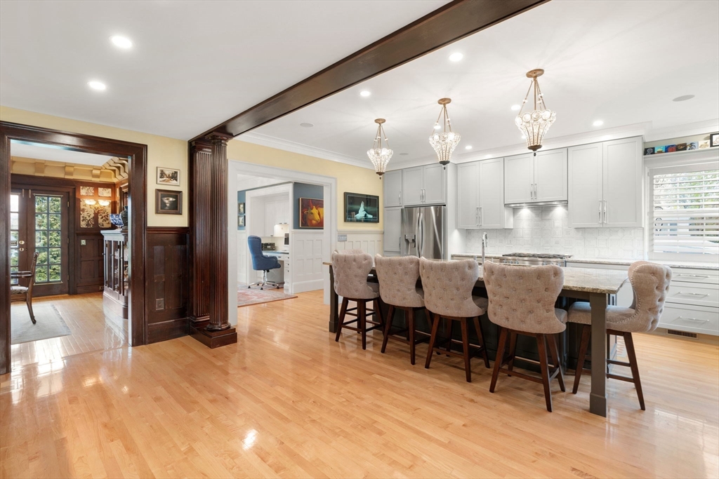 79 Wedge Street Lowell, MA 01851 - Photo 12 of 42 a large kitchen with cabinets chairs and refrigerator
