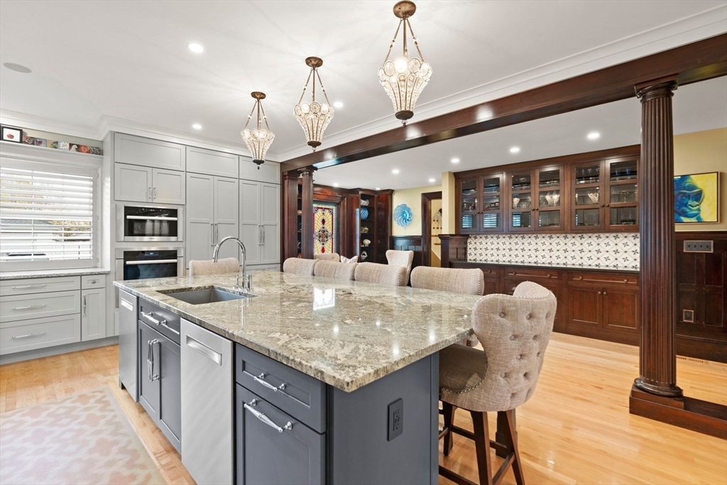 79 Wedge Street Lowell, MA 01851 - Photo 16 of 42 a kitchen with stainless steel appliances granite countertop a stove and a wooden floors