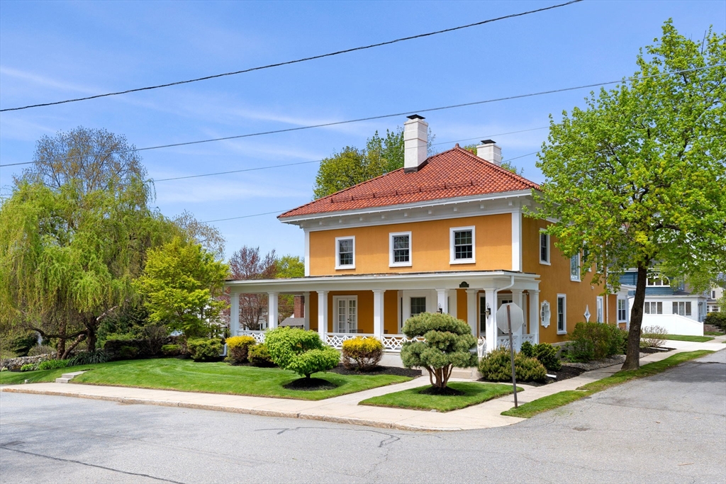 79 Wedge Street Lowell, MA 01851 - Photo 2 of 42 a front view of a house with a yard