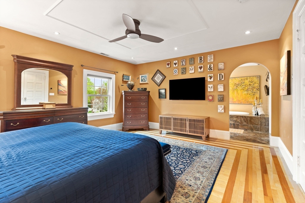 79 Wedge Street Lowell, MA 01851 - Photo 26 of 42 a bedroom with furniture and a flat screen tv